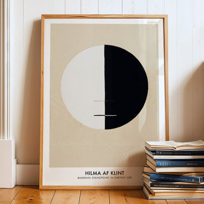Black and white circle artwork poster Buddha Standpoint In Early Life by Hilma AF Klint with divided circle on beige background, framed and displayed in modern living room decor