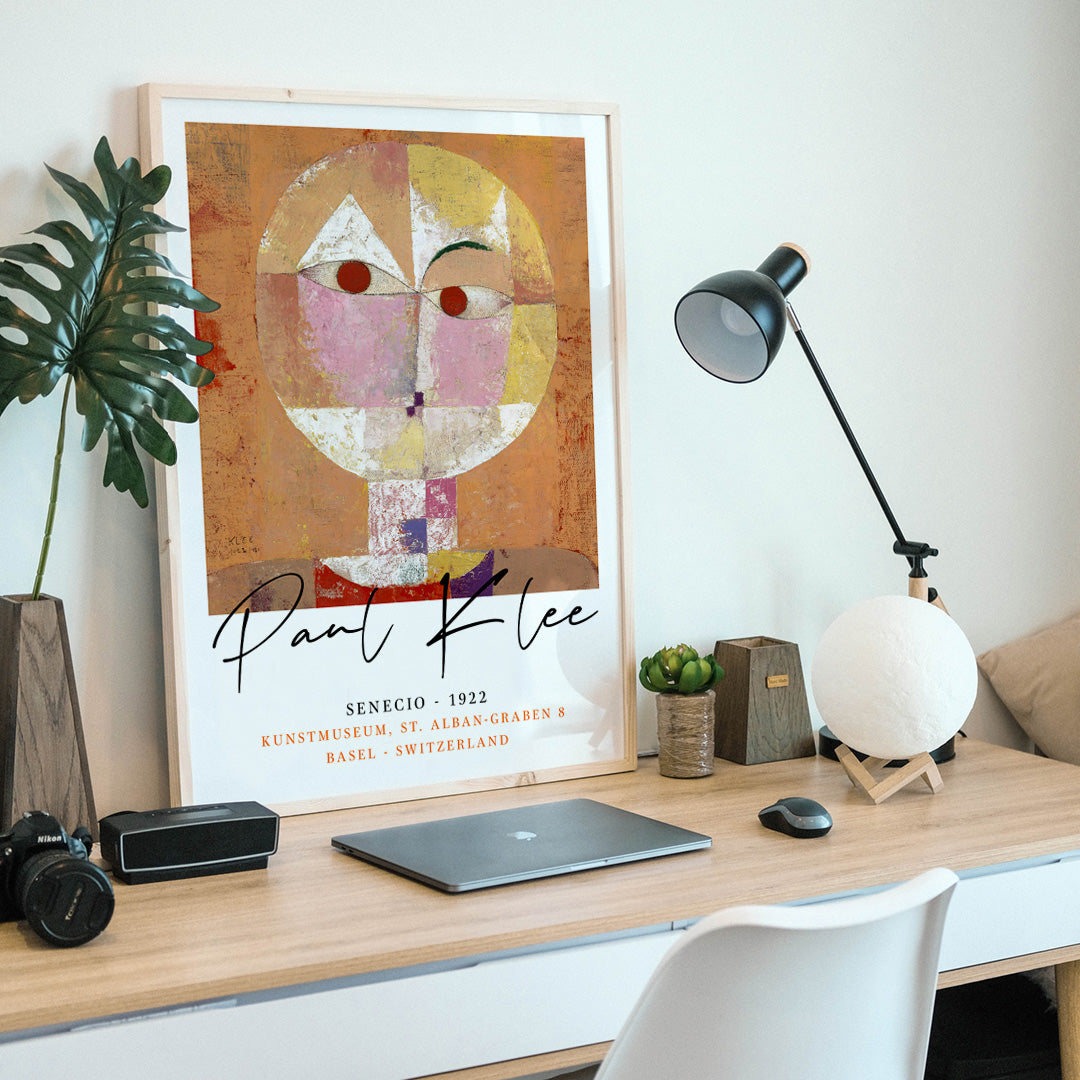Abstract geometric portrait Senecio by Paul Klee with warm colors and geometric shapes on orange background poster, framed and displayed in home decor