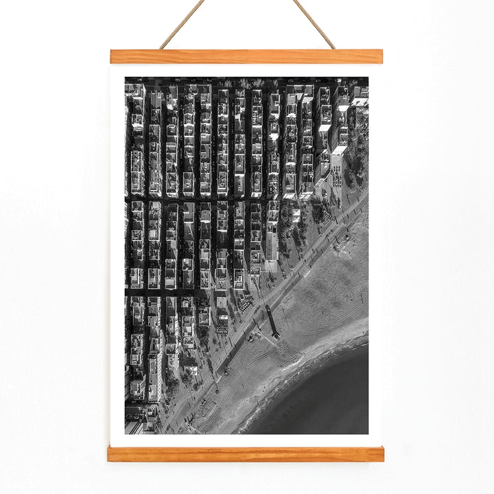 Aerial cityscape and black and white poster of Barceloneta beach and city grid aerial view, with wooden magnetic frame on white background