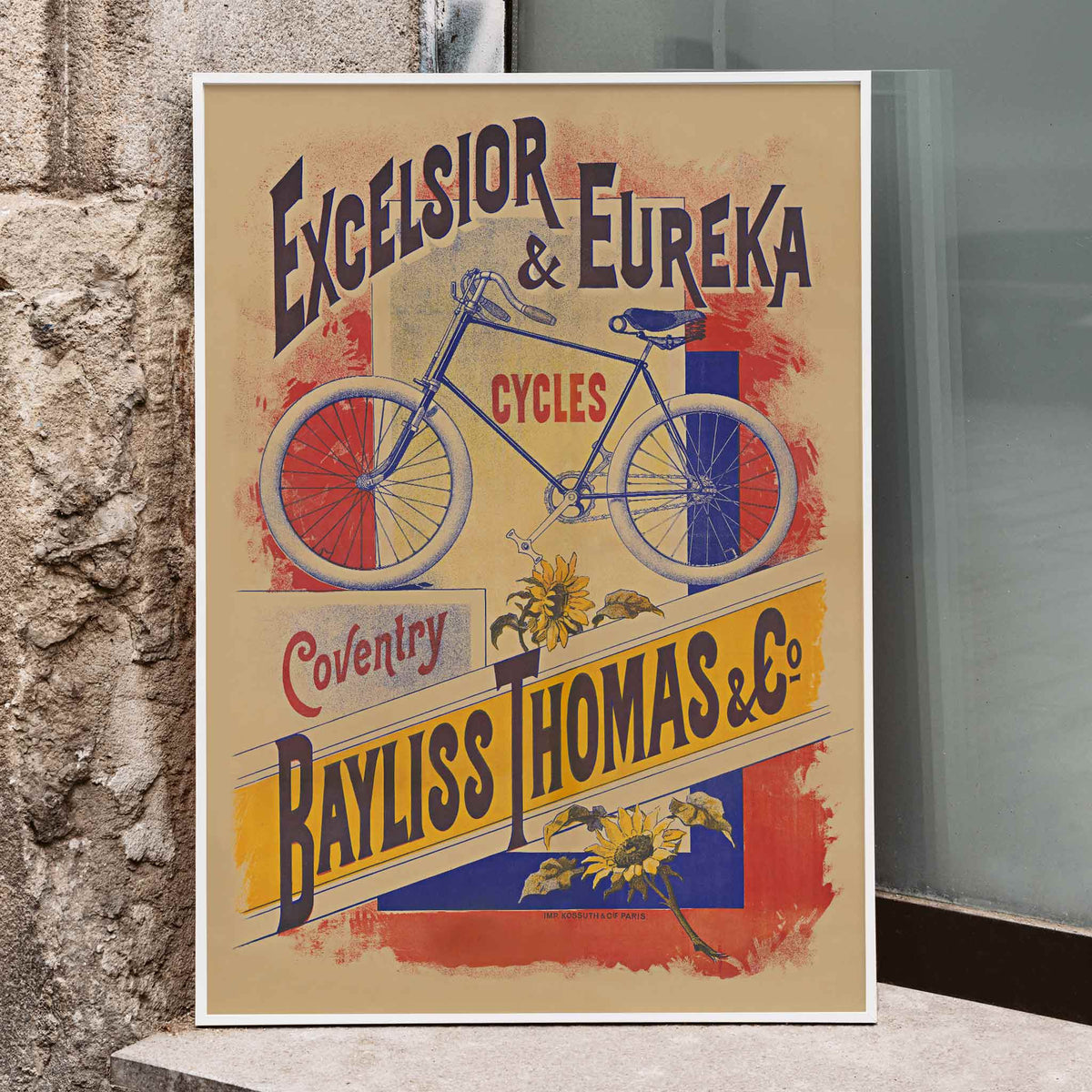 Bayliss Thomas Excelsior and Eureka Cycles vintage poster with blue bicycle and bold lettering, framed and displayed in modern living room decor