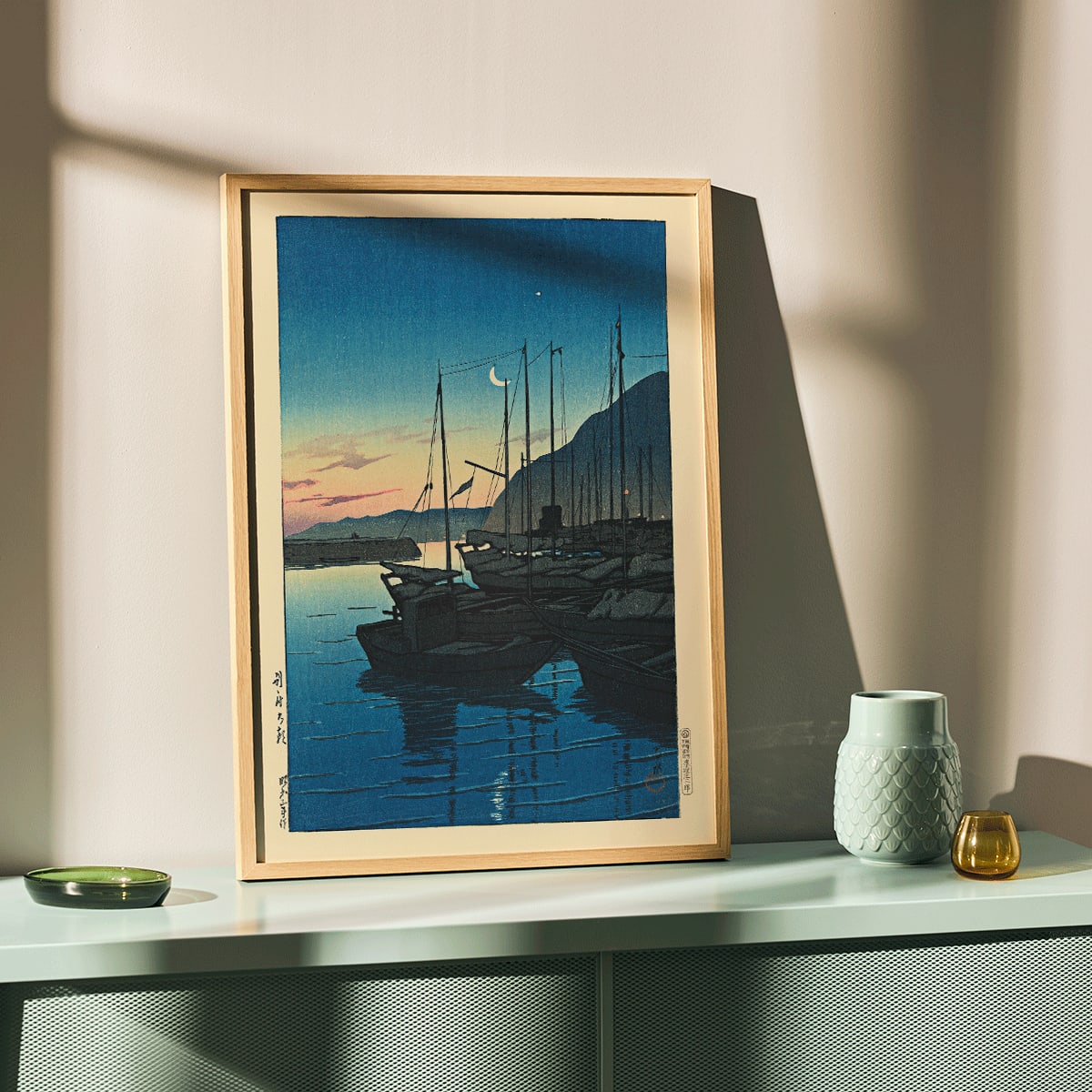 Boats docked at sunrise in a tranquil harbor with mountains in the background Morning in Beppu by Kawase Hasui, framed and displayed in modern living room decor