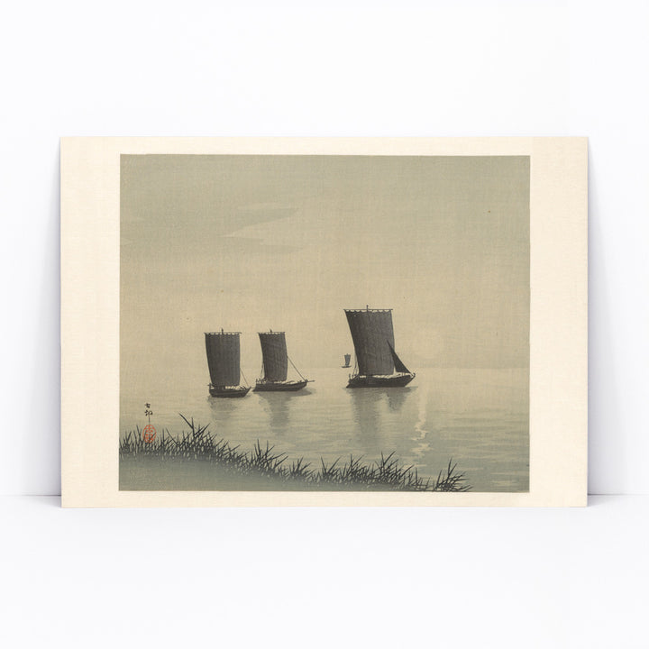 Serene Japanese art of three traditional fishing boats on calm water at sunset by Ohara Koson, framed and displayed in modern living room decor
