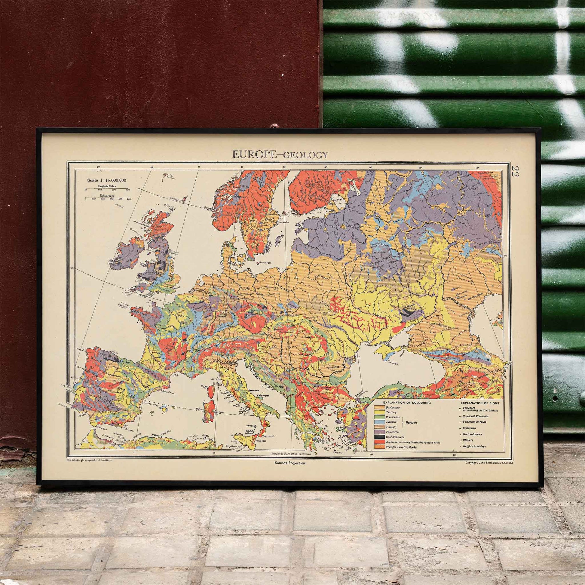 John George Bartholomew Europe geology map poster with colorful geological regions in vintage scientific style, framed and displayed in modern living room decor