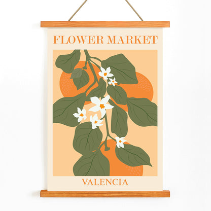 Flower Market Valencia by Moryarty poster illustration with green leaves and white flowers on orange background, with wooden magnetic frame on white background