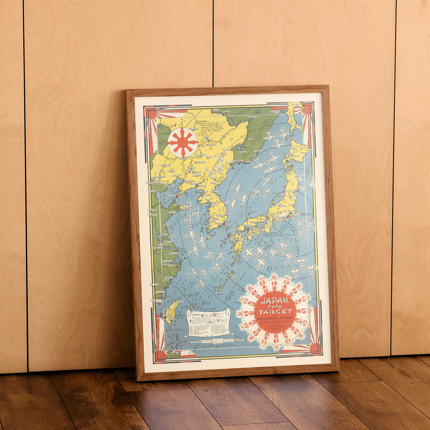 Colorful illustrated map of Japan and surrounding regions by Ernest Dudley Chase titled Japan the Target a Pictorial Jap-map poster, framed and displayed in home decor