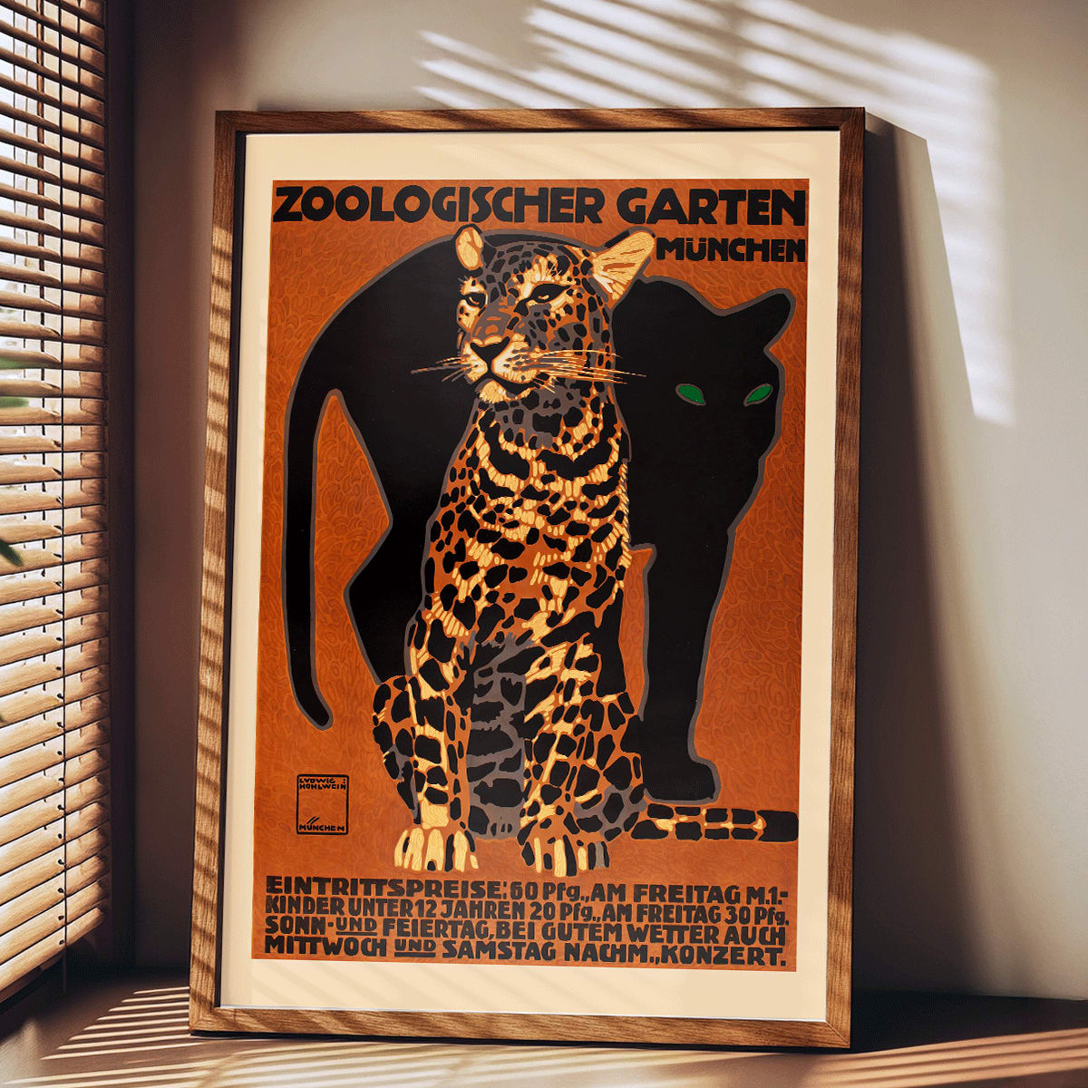 Leopard and black panther poster for Zoologischer Garten München by Ludwig Hohlwein featuring bold text artwork, framed and displayed in modern living room decor