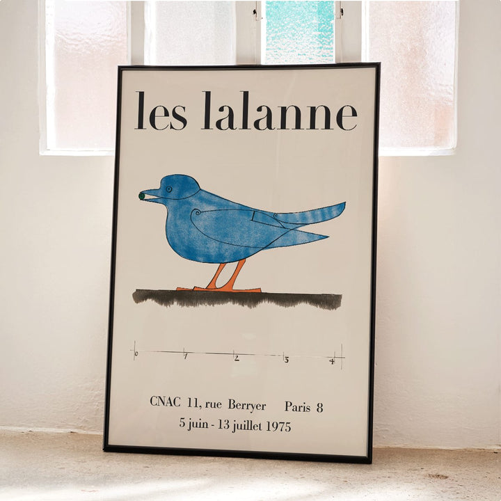 Les Lalanne Exhibition poster by Francois Xavier Lalanne featuring a stylized blue bird with orange legs on beige background, framed and displayed in home decor