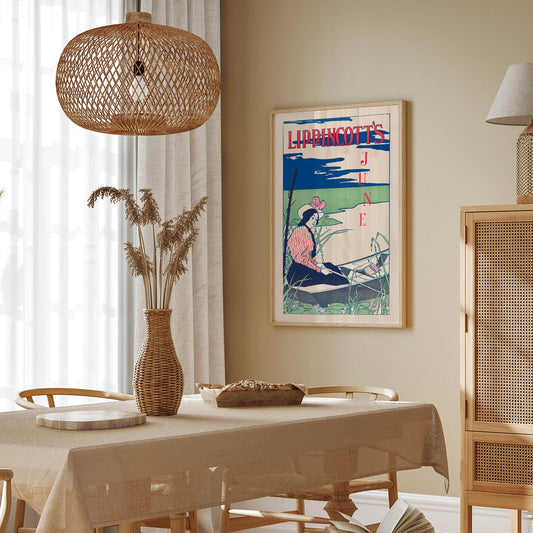 Woman boating on a serene river wearing a striped dress and hat surrounded by reeds and water lilies Lippincotts June by William Carqueville, framed and displayed in home decor