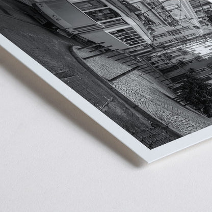 Closeup detail of Lisbon Tramway 28 Black and White historic tram navigating cobblestone streets in Lisbon street scene poster
