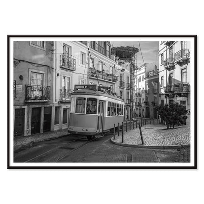 Lisbon Tramway 28 Black and White historic tram navigating cobblestone streets in Lisbon street scene poster, with black aluminium frame on white background