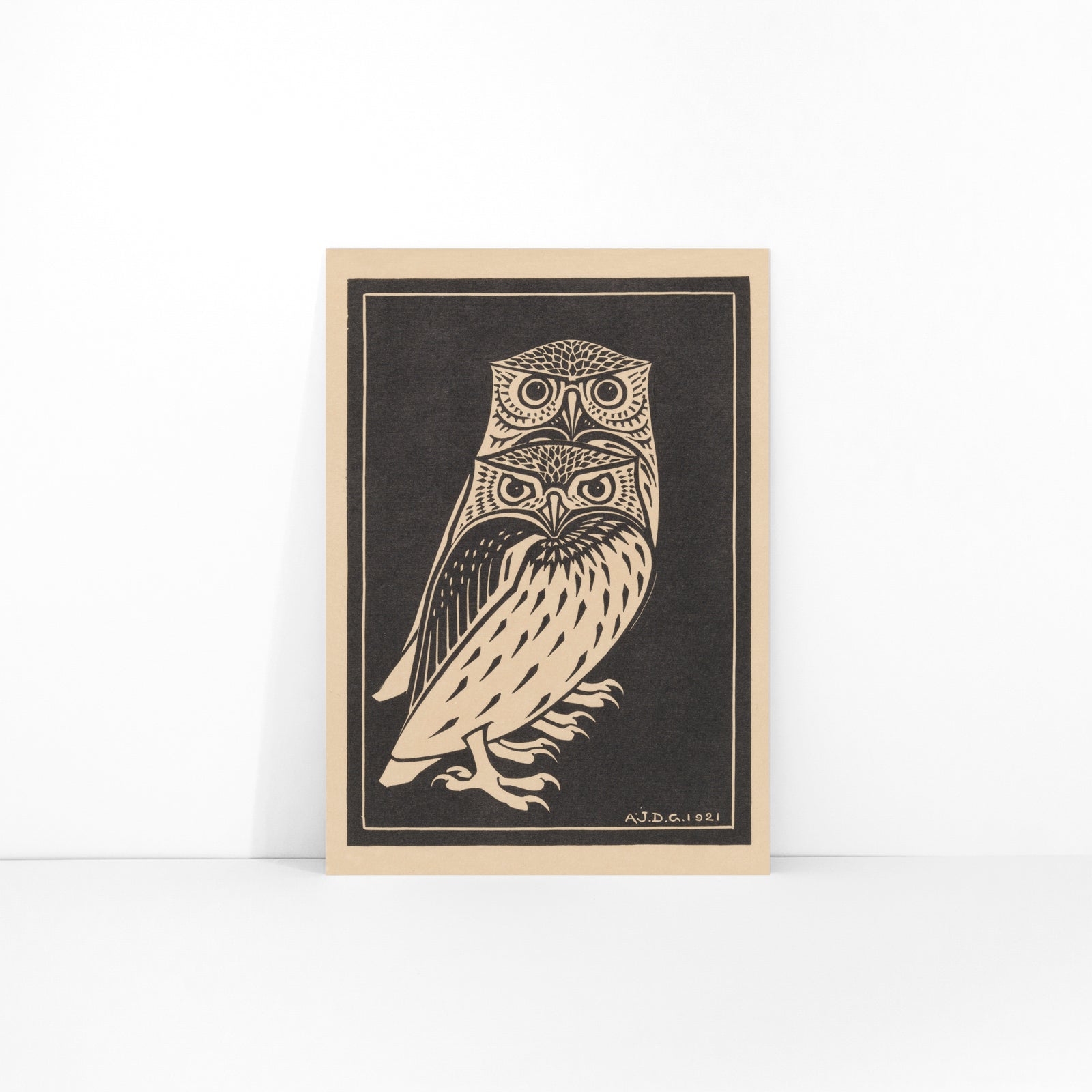 Stylized black and white owls artwork by Julie de Graag titled Two black and white owls illustration and poster, framed and displayed in modern living room decor