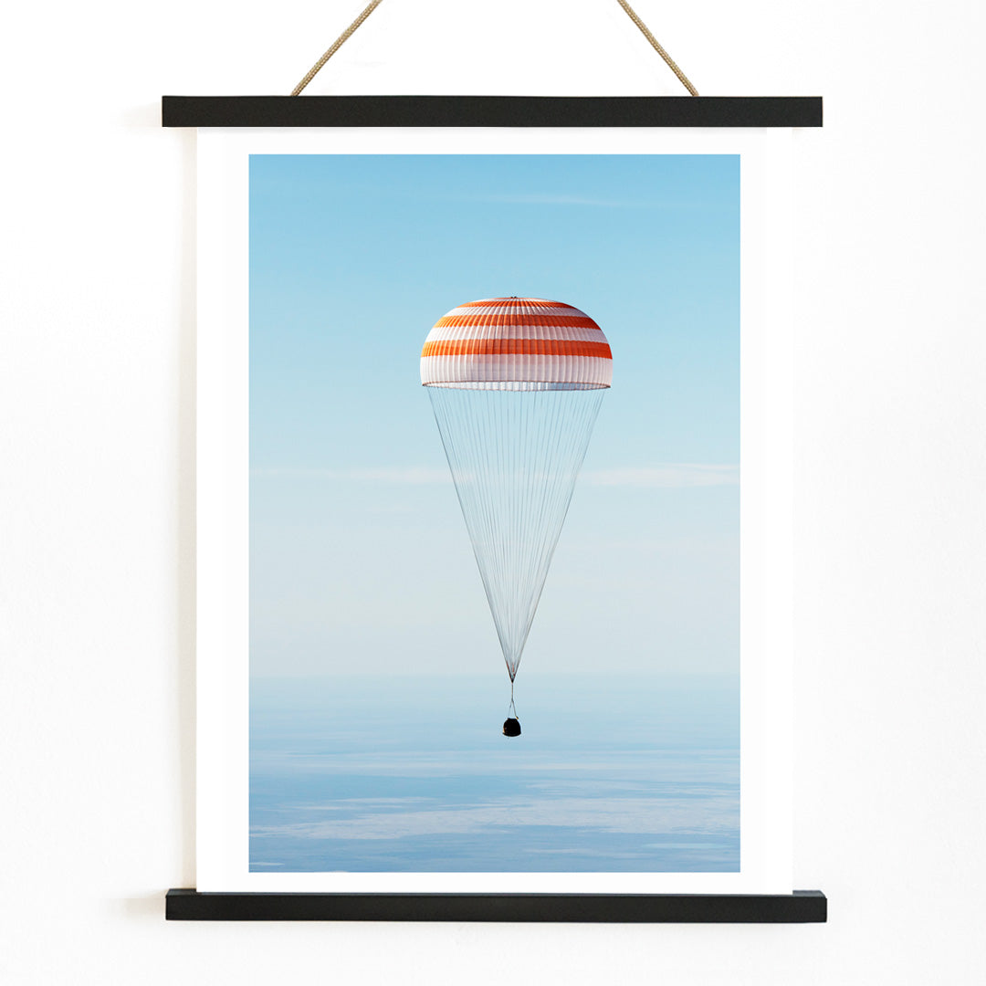 Soyuz MS-02 spacecraft descending with parachute over Kazakhstan NASA poster titled The Soyuz MS-02 spacecraft lands, with wooden magnetic frame on white background