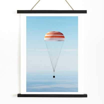 Soyuz MS-02 spacecraft descending with parachute over Kazakhstan NASA poster titled The Soyuz MS-02 spacecraft lands, with wooden magnetic frame on white background