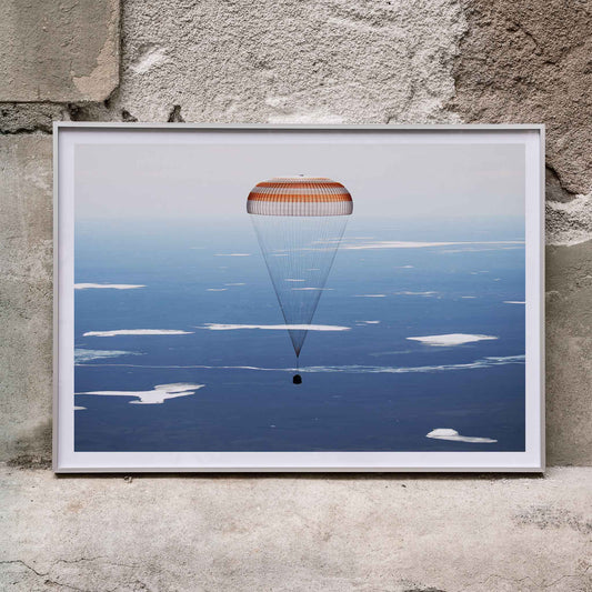 Soyuz MS-02 spacecraft descending with parachute over Kazakhstan NASA poster artwork showing landing, framed and displayed in home decor