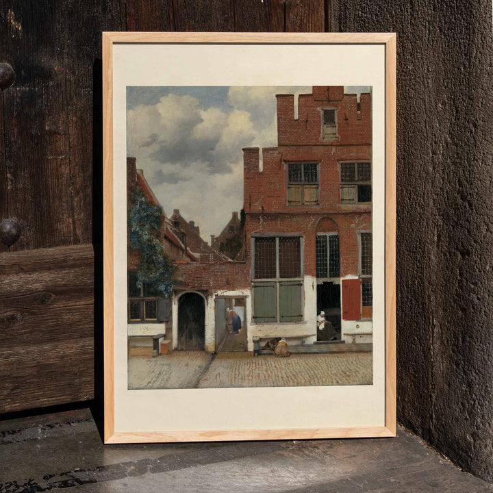 Poster of a charming street scene with brick houses and figures from View of Houses in Delft The Little Street by Johannes Vermeer, framed and displayed in home decor