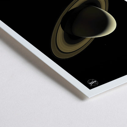 Closeup detail of NASA illustration and poster of planet Saturn with rings against black background