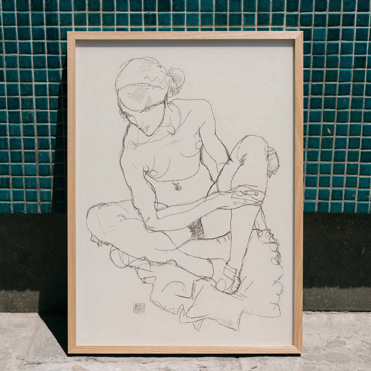 Egon Schiele Seated Nude Woman poster with delicate black linework on minimalist white background, framed and displayed in modern living room decor