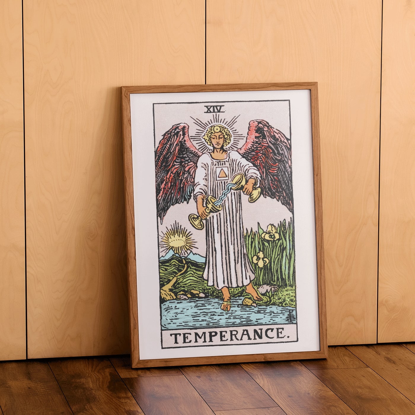 Temperance tarot card by Rider Waite featuring an angel with wings pouring liquid between two cups illustration and poster, framed and displayed in home decor