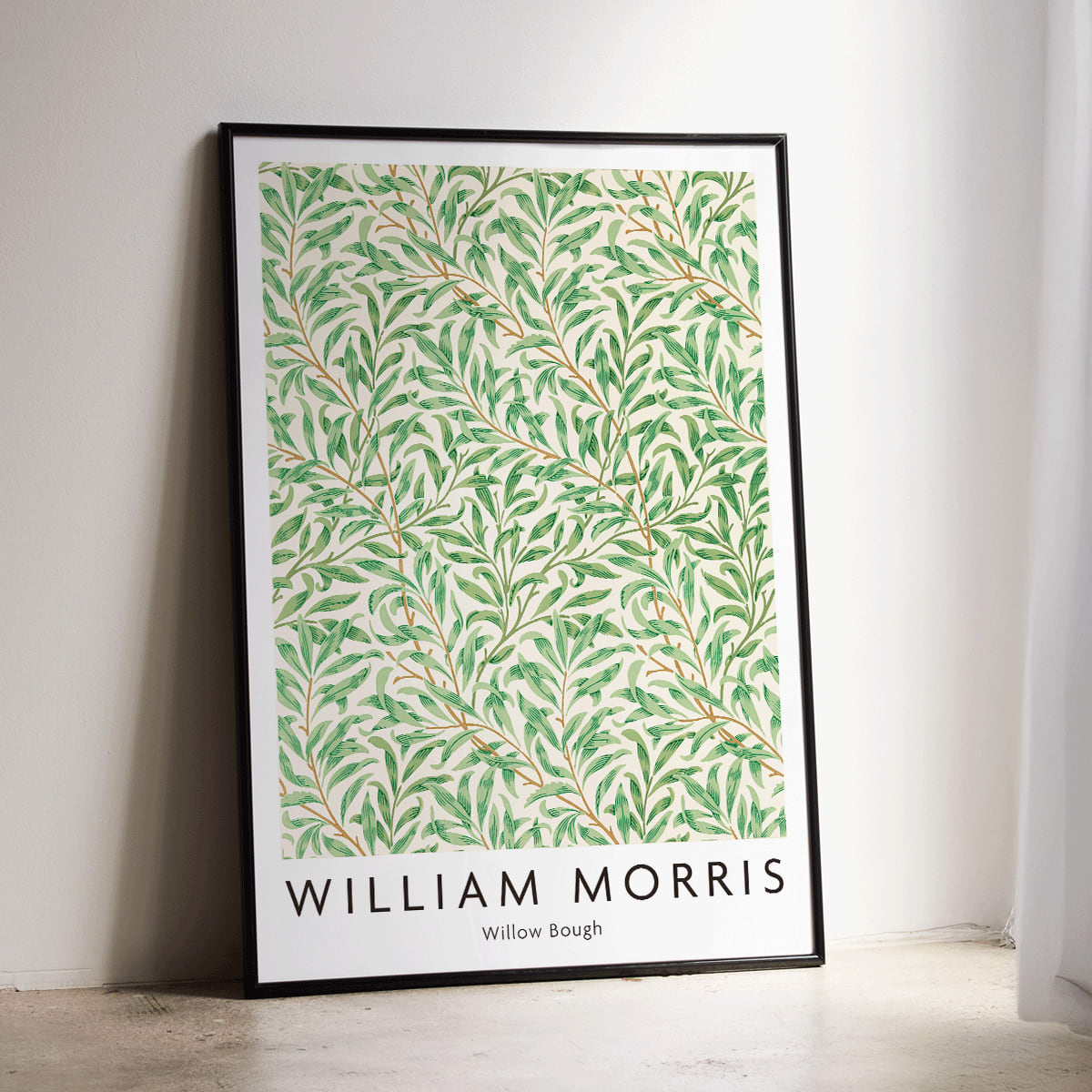 Willow Bough by William Morris leafy botanical pattern poster with intricate green willow branches and leaves on light background, framed and displayed in modern living room decor